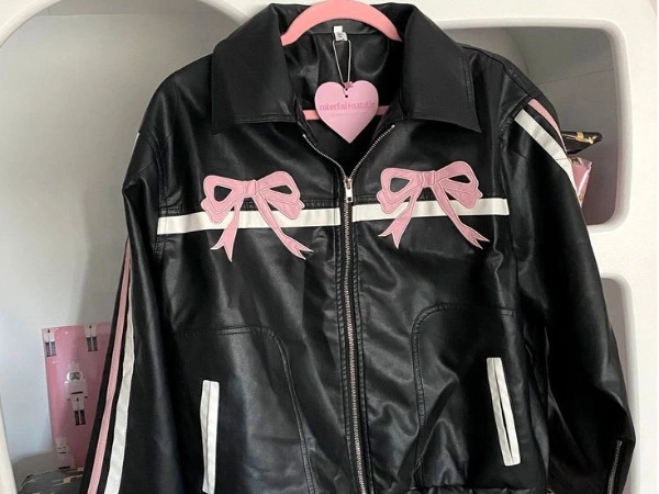 Pink bow black leather jacket hanged